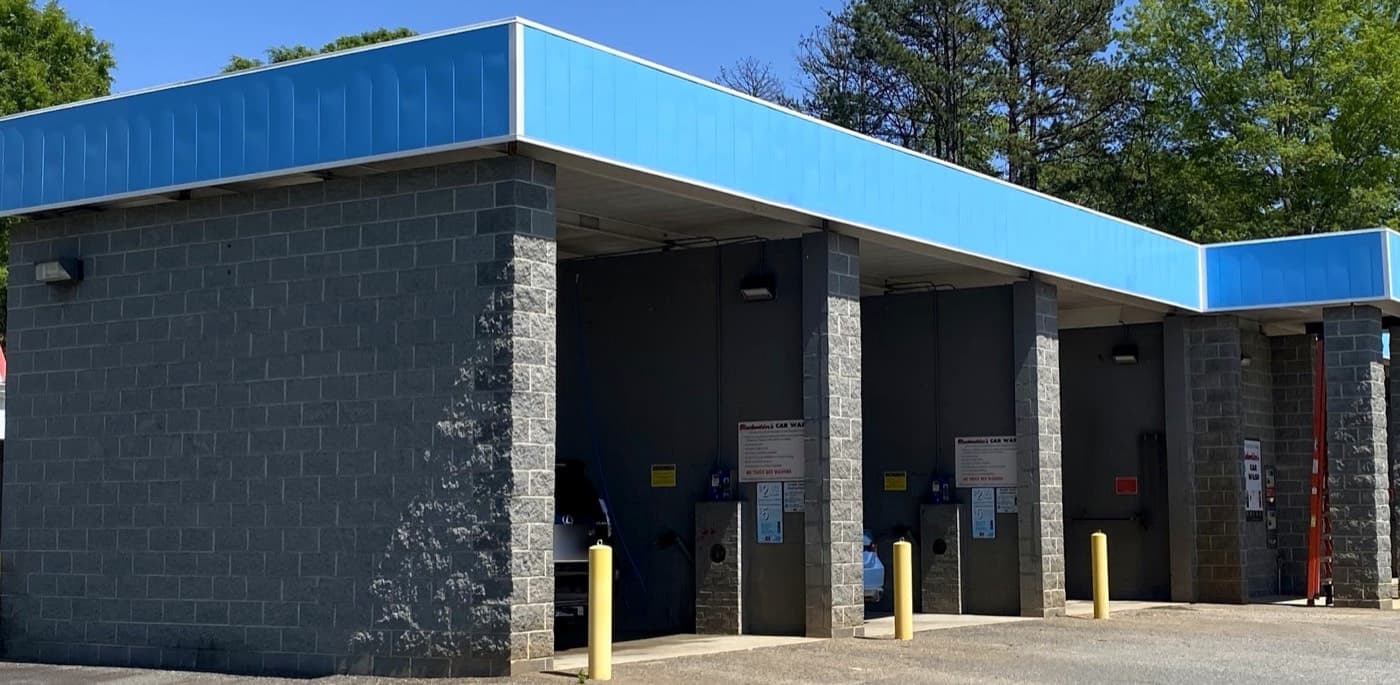 Car wash in Concord, NC, with recoated blue exterior siding above masonry wash bays