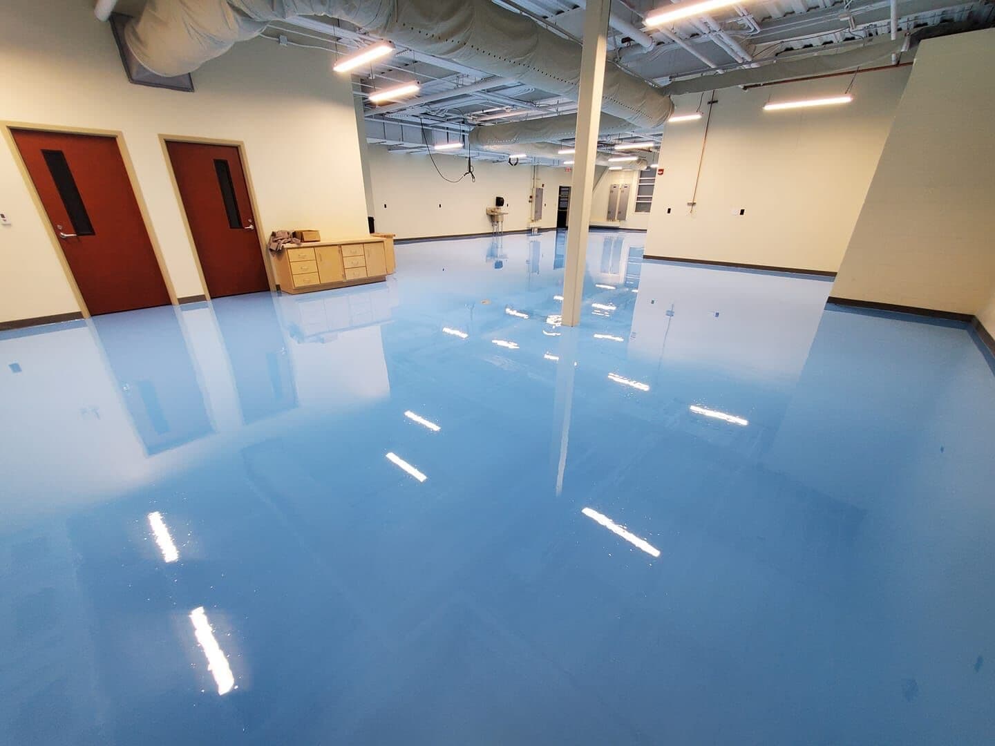 High-gloss blue resinous epoxy floor in a new North Carolina manufacturing facility