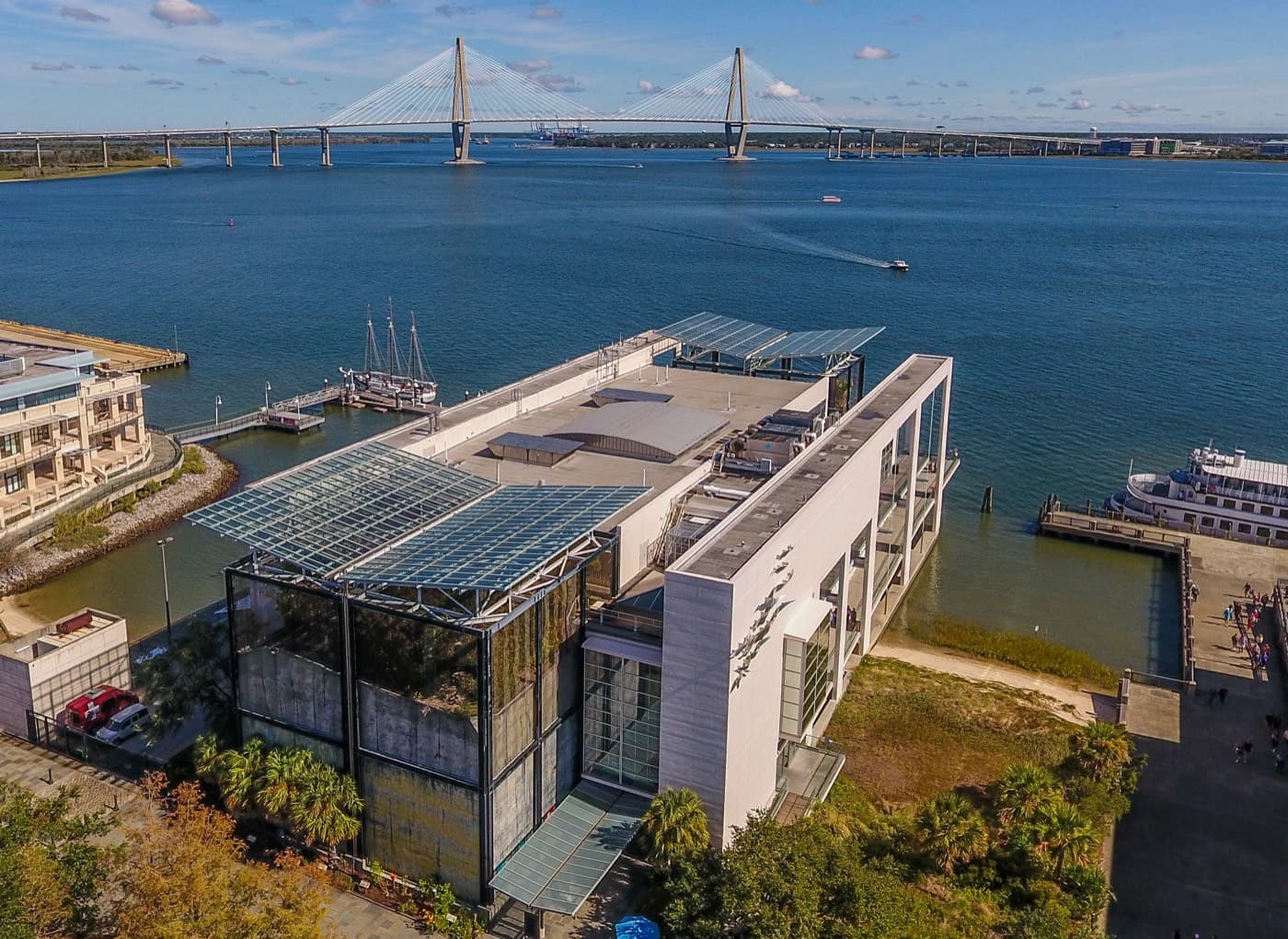 Aerial view of the South Carolina Aquarium on Charleston Harbor with the Ravenel Bridge in the background